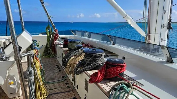 Little Giant Yacht Photos Pics Deck of 2017 Sunreef 88 DD yacht with ropes and winches, overlooking blue ocean.