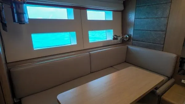 Little Giant Yacht Photos Pics Interior of 2017 Sunreef 88 DD yacht with seating area and windows.