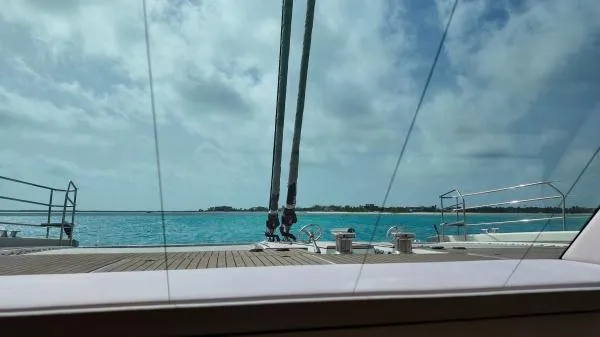 Little Giant Yacht Photos Pics View from Sunreef 88 DD yacht, 2017, overlooking serene turquoise waters and clear skies.