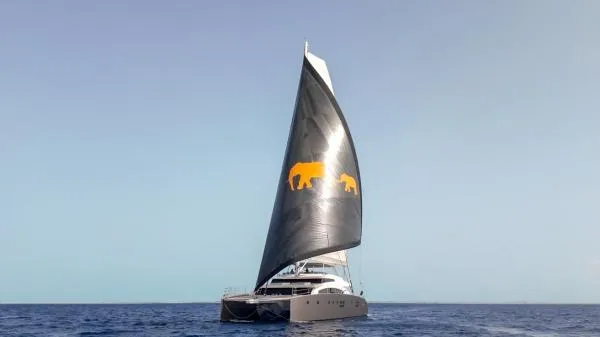 Little Giant Yacht Photos Pics Luxury Sunreef 88 DD yacht sailing with distinctive bear graphics on the sail, 2017 model.