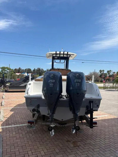  Yacht Photos Pics 2022 SeaHunter 275 ULTRA boat with dual 250 V6 engines, parked on a brick surface.