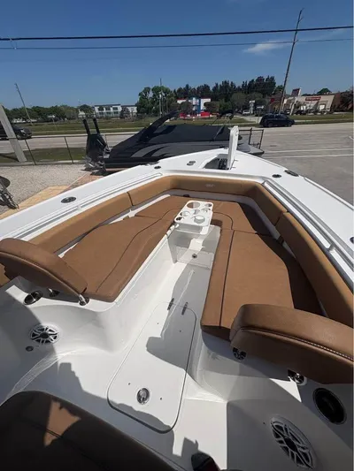  Yacht Photos Pics 2022 SeaHunter 275 ULTRA boat with brown seating and white deck, parked outdoors.