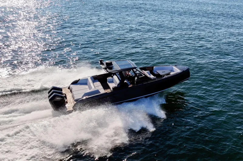  Yacht Photos Pics 2024 Vanquish Yachts 40 speeding on open water, showcasing sleek design and powerful engines.