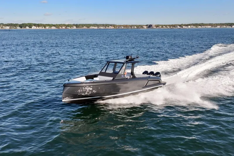  Yacht Photos Pics 2024 Vanquish Yachts 40 cruising on open water, showcasing sleek design and performance.