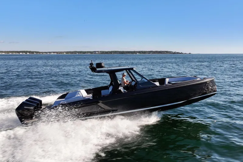  Yacht Photos Pics 2024 Vanquish Yachts 40 speeding on open water, showcasing sleek design and powerful performance.