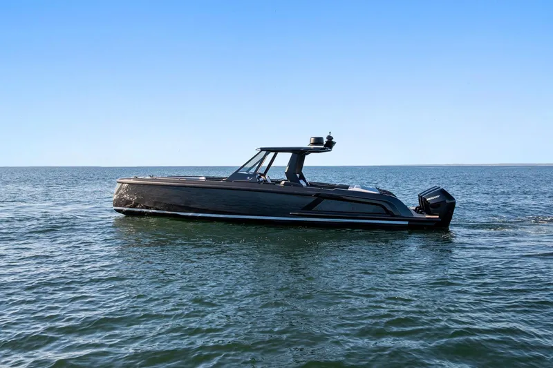  Yacht Photos Pics 2024 Vanquish Yachts 40 cruising on open water under clear blue skies.