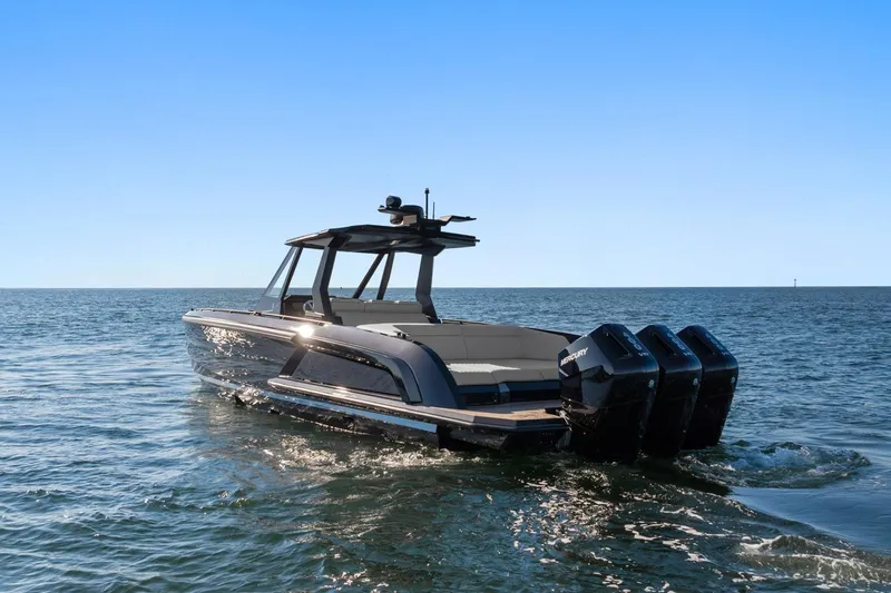  Yacht Photos Pics 2024 Vanquish Yachts 40 on open water, featuring sleek design and triple outboard engines.