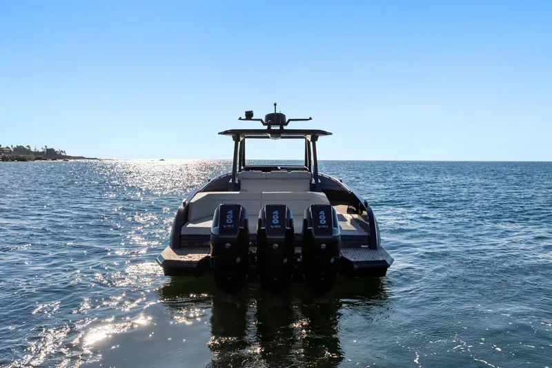  Yacht Photos Pics 2024 Vanquish Yachts 40 on open water, rear view with triple engines.