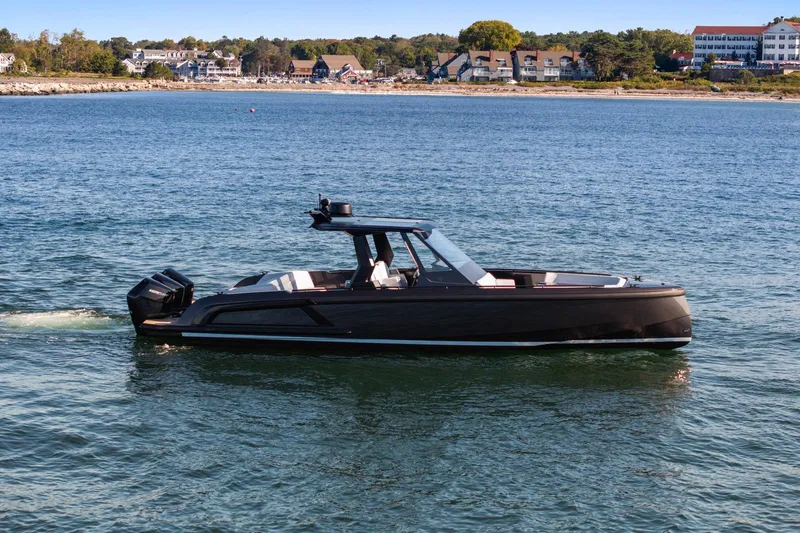  Yacht Photos Pics 2024 Vanquish Yachts 40 cruising on a serene coastal waterway.