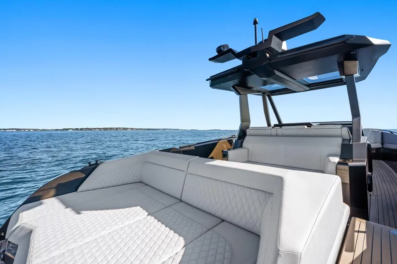  Yacht Photos Pics Luxurious 2024 Vanquish Yachts 40 with elegant seating, cruising on open water.