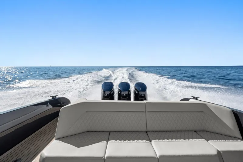  Yacht Photos Pics 2024 Vanquish Yachts 40 cruising on open water, showcasing powerful engines and sleek design.