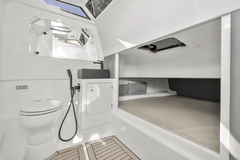  Yacht Photos Pics Luxurious 2024 Vanquish Yachts 40 interior with modern bathroom and sleeping area.