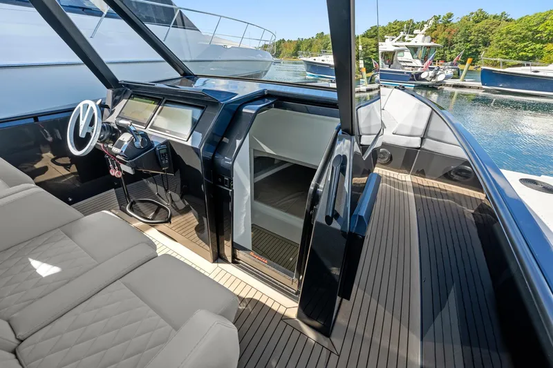  Yacht Photos Pics 2024 Vanquish Yachts 40 interior with sleek helm, luxurious seating, and modern design.