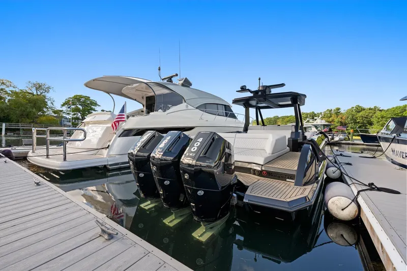  Yacht Photos Pics 2024 Vanquish Yachts 40 docked, featuring powerful outboard engines and sleek design.