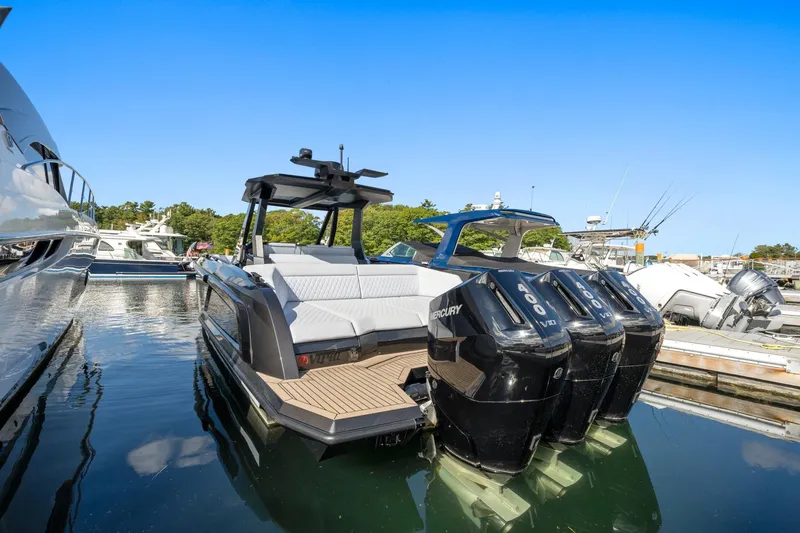  Yacht Photos Pics 2024 Vanquish Yachts 40 with powerful Mercury engines docked in a marina.