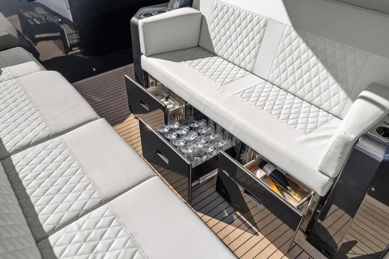  Yacht Photos Pics Luxurious seating with storage on 2024 Vanquish Yachts 40, featuring elegant design and functionality.