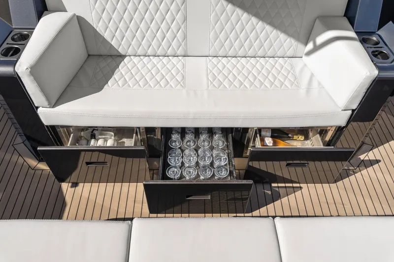  Yacht Photos Pics Luxurious seating with storage on 2024 Vanquish Yachts 40, featuring drinks and accessories.
