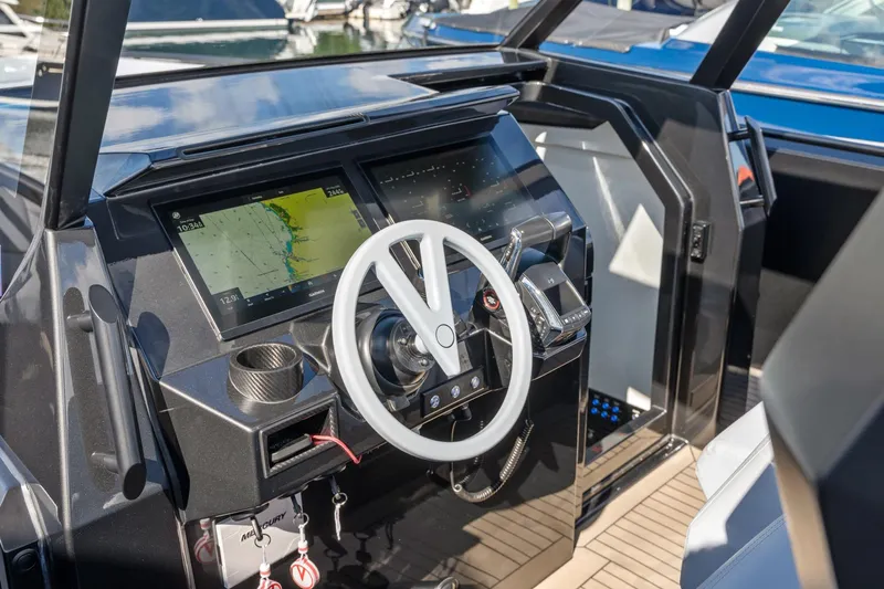  Yacht Photos Pics 2024 Vanquish Yachts 40 helm with modern navigation displays and sleek steering wheel.