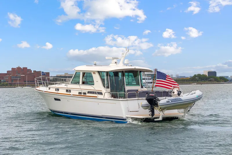 Second Rodeo Yacht Photos Pics 2018 Sabre 48 Salon Express yacht cruising on a sunny day with American flag.