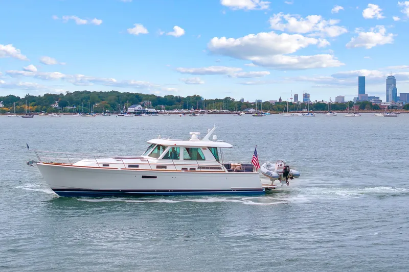 Second Rodeo Yacht Photos Pics 2018 Sabre 48 Salon Express yacht cruising near city skyline on a sunny day.