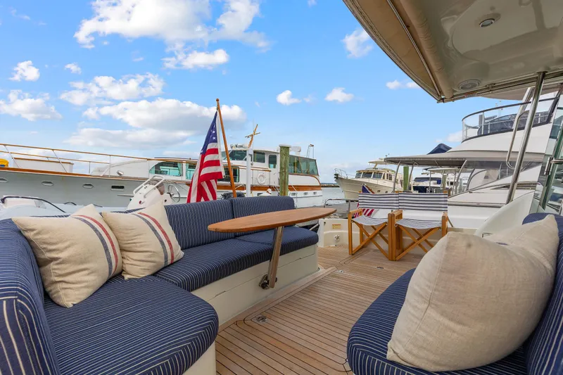 Second Rodeo Yacht Photos Pics 2018 Sabre 48 Salon Express yacht deck with seating, table, and American flag.