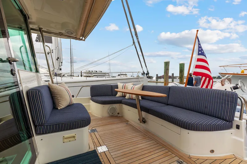 Second Rodeo Yacht Photos Pics 2018 Sabre 48 Salon Express yacht with striped seating and American flag at dock.