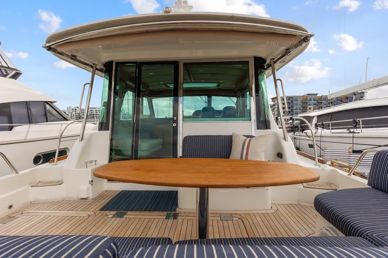 Second Rodeo Yacht Photos Pics 2018 Sabre 48 Salon Express yacht with outdoor seating and wooden table.