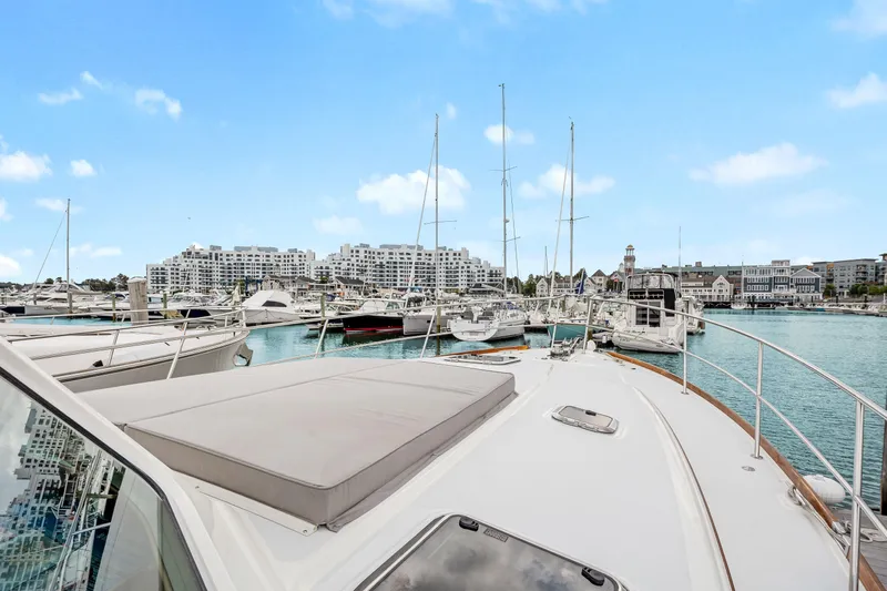 Second Rodeo Yacht Photos Pics 2018 Sabre 48 Salon Express yacht docked in a marina with cityscape background.