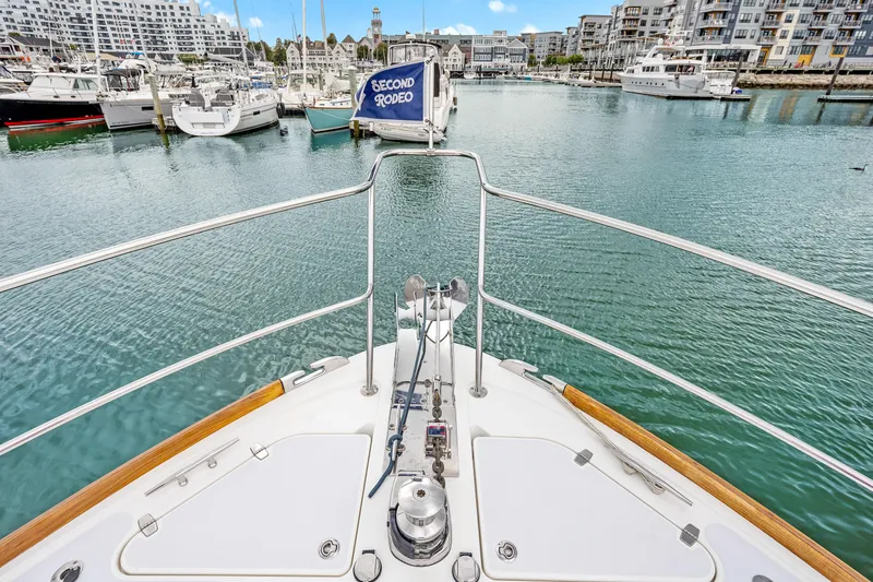Second Rodeo Yacht Photos Pics Bow view of 2018 Sabre 48 Salon Express in a marina setting.
