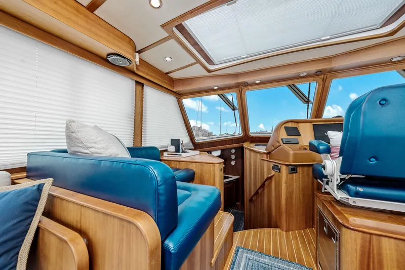 Second Rodeo Yacht Photos Pics Interior of 2018 Sabre 48 Salon Express yacht with blue seating and wooden finishes.