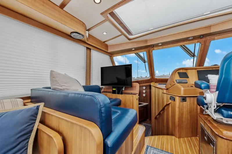 Second Rodeo Yacht Photos Pics Interior of 2018 Sabre 48 Salon Express yacht with blue seating and wooden accents.