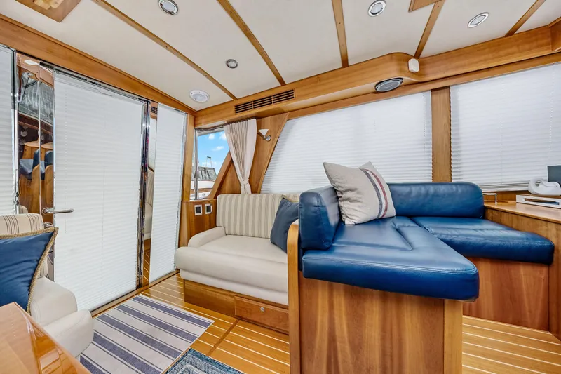 Second Rodeo Yacht Photos Pics Luxurious interior of 2018 Sabre 48 Salon Express yacht with plush seating and wooden accents.