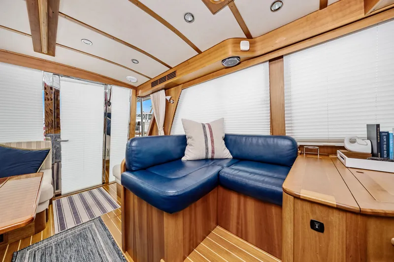 Second Rodeo Yacht Photos Pics 2018 Sabre 48 Salon Express interior with blue leather seating and wooden accents.