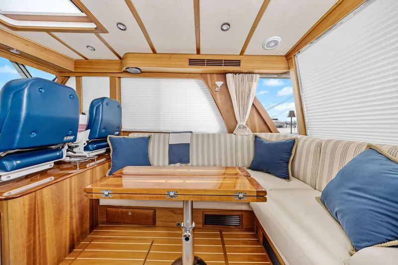 Second Rodeo Yacht Photos Pics Luxurious interior of 2018 Sabre 48 Salon Express yacht with plush seating and wooden accents.