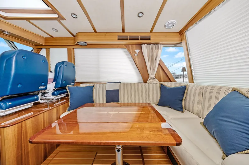 Second Rodeo Yacht Photos Pics Interior of 2018 Sabre 48 Salon Express yacht with elegant seating and wooden table.
