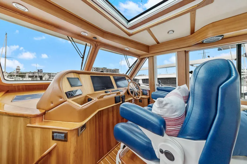 Second Rodeo Yacht Photos Pics Interior of 2018 Sabre 48 Salon Express yacht with blue seats and wooden dashboard.