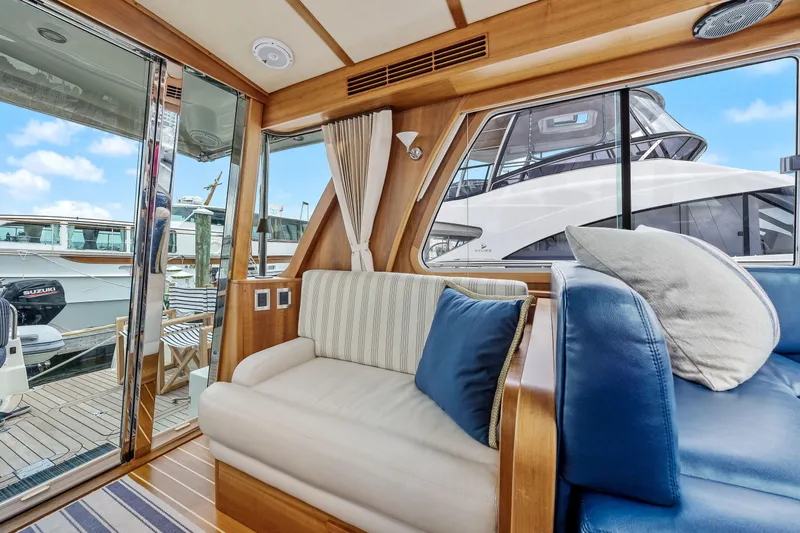 Second Rodeo Yacht Photos Pics Interior of 2018 Sabre 48 Salon Express yacht with plush seating and marina view.