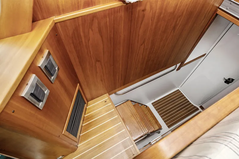 Second Rodeo Yacht Photos Pics Interior stairs of 2018 Sabre 48 Salon Express yacht, featuring wooden finish and modern design.