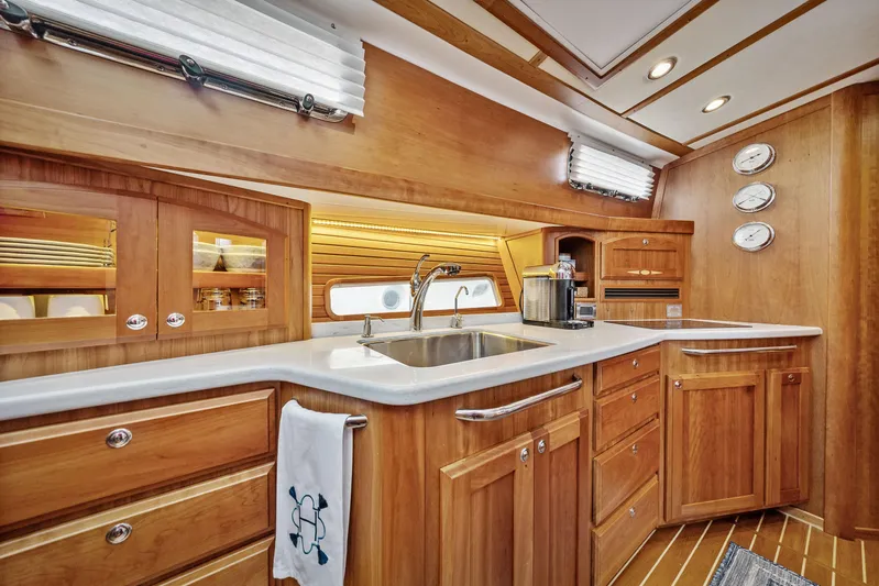 Second Rodeo Yacht Photos Pics Luxurious 2018 Sabre 48 Salon Express yacht kitchen with wood cabinetry and modern amenities.