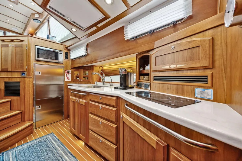 Second Rodeo Yacht Photos Pics Luxurious 2018 Sabre 48 Salon Express yacht interior with modern kitchen and wooden cabinetry.