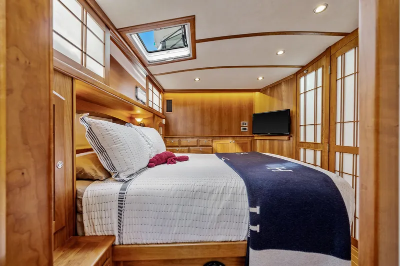 Second Rodeo Yacht Photos Pics Luxurious 2018 Sabre 48 Salon Express bedroom with elegant wood paneling and skylight.