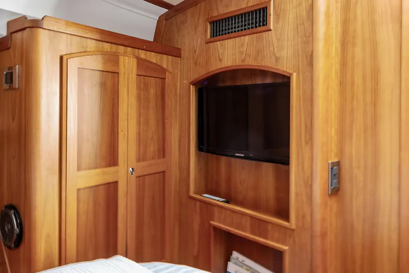 Second Rodeo Yacht Photos Pics Interior of 2018 Sabre 48 Salon Express with wooden cabinetry and built-in TV.