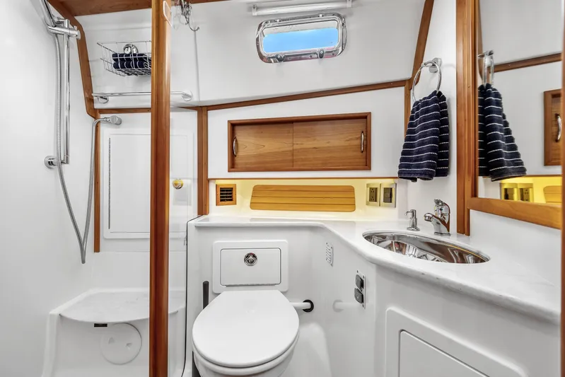 Second Rodeo Yacht Photos Pics Luxurious bathroom in 2018 Sabre 48 Salon Express yacht with wood accents and modern fixtures.