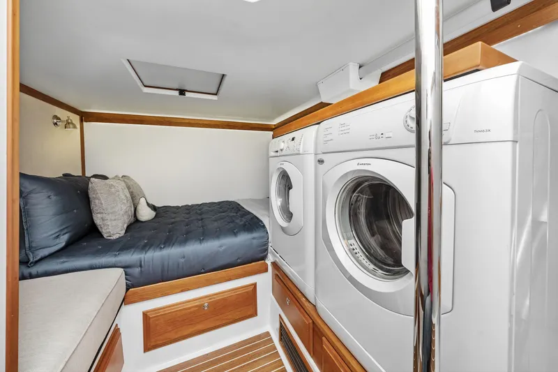Second Rodeo Yacht Photos Pics Laundry area with bed in 2018 Sabre 48 Salon Express yacht interior.
