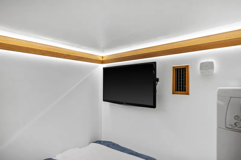 Second Rodeo Yacht Photos Pics Interior of 2018 Sabre 48 Salon Express with TV, speaker, and modern lighting.