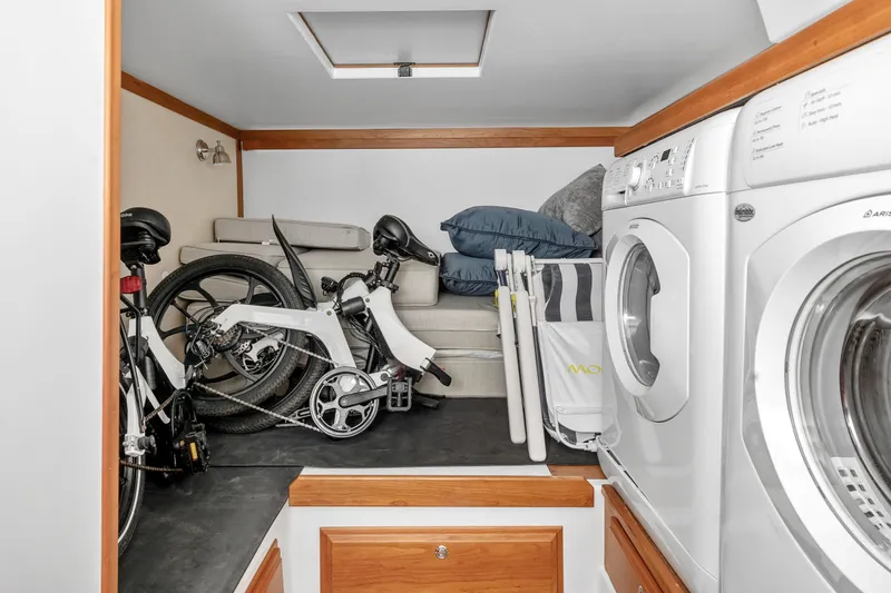 Second Rodeo Yacht Photos Pics Laundry area with folding bike and sofa in 2018 Sabre 48 Salon Express.