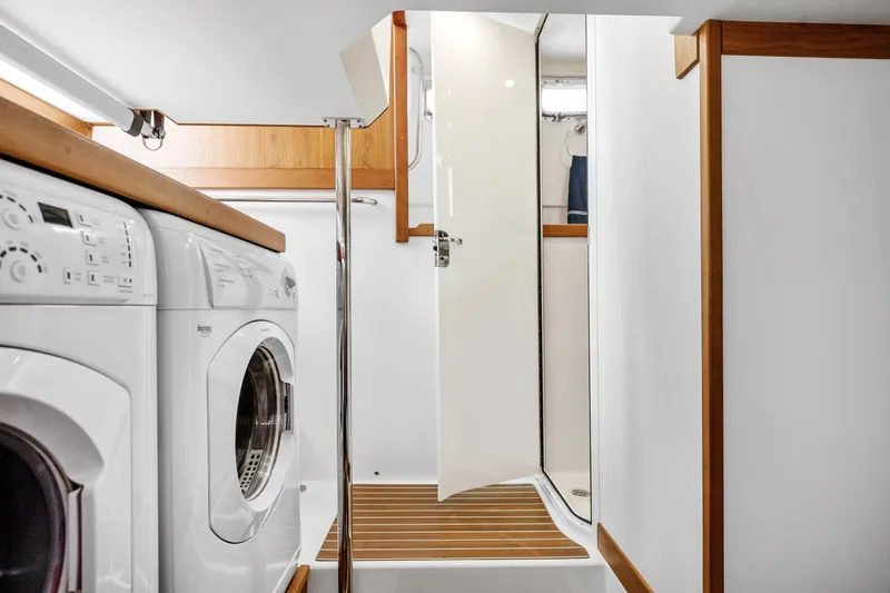 Second Rodeo Yacht Photos Pics Laundry area with washer, dryer, and shower on 2018 Sabre 48 Salon Express yacht.