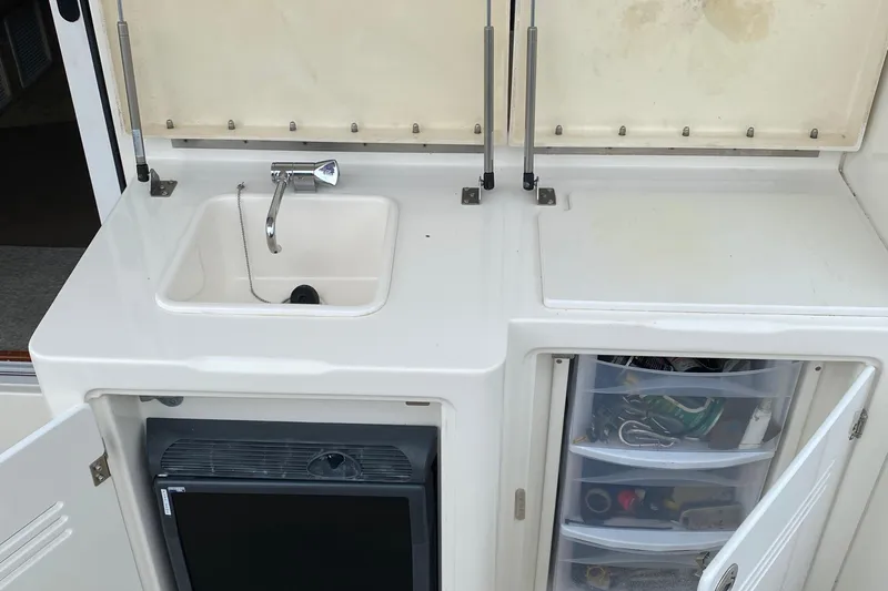 Carousel Yacht Photos Pics 2007 Silverton 36 Convertible yacht kitchenette with sink, storage, and mini fridge.