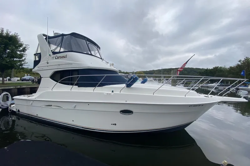 Carousel Yacht Photos Pics 2007 Silverton 36 Convertible yacht docked, featuring sleek design and American flag.