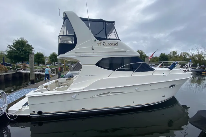 Carousel Yacht Photos Pics 2007 Silverton 36 Convertible yacht docked at marina, overcast sky.
